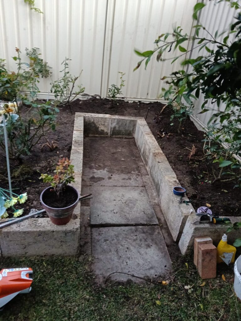 Raised garden bed after weeds and unwanted growth were cleared in Cockburn, WA.